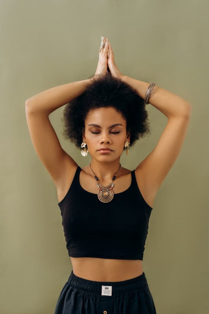 A woman in a yoga pose with closed eyes, symbolizing tranquility and self-awareness.